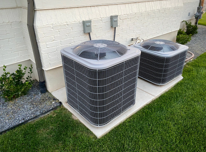 exterior hvac unit newly installed beside residential house lawn landscape